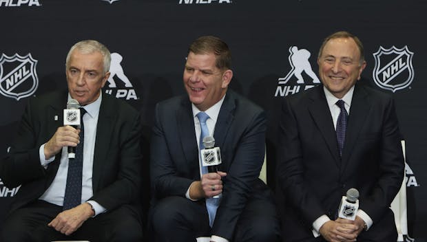 (L-R) IIHF president Luc Tarif, NHLPA executive director Marty Walsh and NHL commissioner Gary Bettman speak with the media on February 2, 2024