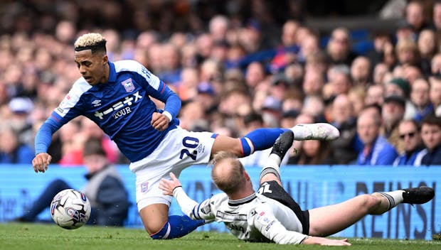 IPSWICH, ENGLAND - MARCH 16: Omari Hutchinson of Ipswich Town is tackled by s10 during the Sky Bet Championship match between Ipswich Town and Sheffield Wednesday at Portman Road on March 16, 2024 in Ipswich, England. (Photo by Justin Setterfield/Getty Images)