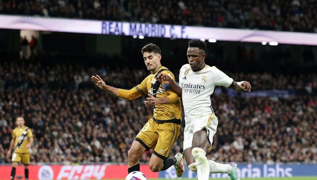 MADRID, SPAIN - NOVEMBER 05: Vinicius Junior (R of Real Madrid CF controls the ball Oscar Valentin (L) of Rayo Vallecano de Madrid during the LaLiga EA Sports match between Real Madrid CF and Rayo Vallecano at Estadio Santiago Bernabeu on November 05, 2023 in Madrid, Spain. (Photo by